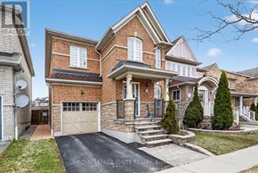 Ajax (Northwest Ajax) apartment for rent - A house with a brick facade and a white garage door is for sale.