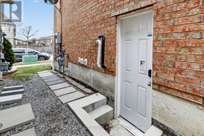 Ajax (Northwest Ajax) apartment for rent - A white door is on the right side of a brick wall.