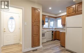 Hamilton (Westcliffe) apartment for rent - A kitchen with wooden cabinets and a white refrigerator.