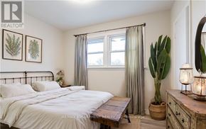 Hamilton (Westcliffe) apartment for rent - A bedroom with a bed, nightstand, and a plant.