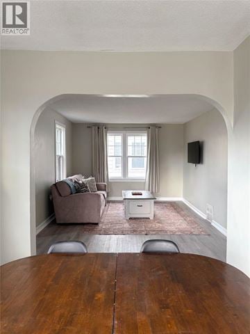 Sarnia apartment for rent - A living room with a brown couch and a white coffee table.