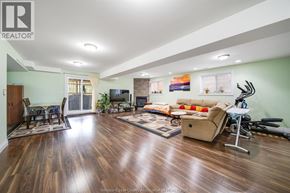 Windsor apartment for rent - A spacious living room with hardwood floors and a variety of furniture.