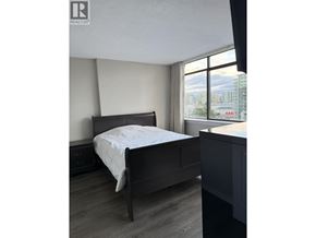 Richmond apartment for rent - A bedroom with a bed, nightstand, and window.