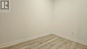 Toronto (Don Valley Village) condo for rent - A room with wooden flooring and a logo that says "REALTOR" on the wall.