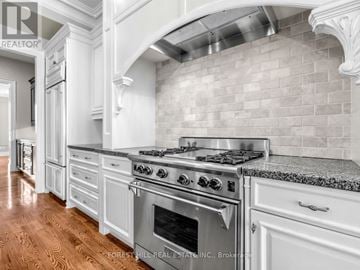 Toronto (St. Andrew-Windfields) apartment for rent - A kitchen with a stove top oven and a backsplash made of tiles.