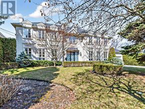 Toronto (St. Andrew-Windfields) apartment for rent - A large white house with a well-manicured lawn in front.