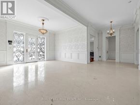Toronto (St. Andrew-Windfields) apartment for rent - A spacious room with marble flooring and white walls.