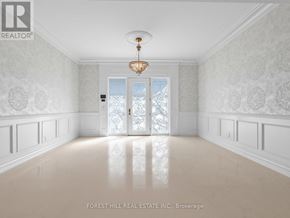 Toronto (St. Andrew-Windfields) apartment for rent - A hallway with a chandelier and a door with a glass panel.