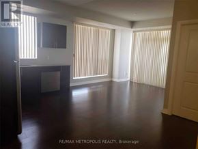 Markham (Wismer) condo for rent - A spacious room with wooden floors and white walls.