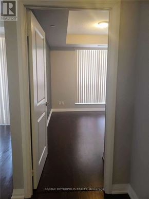 Markham (Wismer) condo for rent - A hallway with a white door and a window with blinds.
