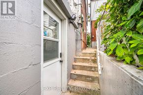 Toronto (Dovercourt-Wallace Emerson-Junction) apartment for rent - A white door is at the end of a staircase.