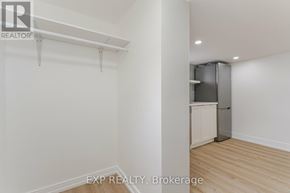 Toronto (Dovercourt-Wallace Emerson-Junction) apartment for rent - A white wall with a kitchen in the corner.