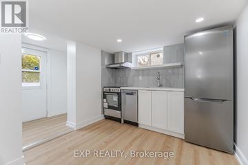 Toronto (Dovercourt-Wallace Emerson-Junction) apartment for rent - A kitchen with white cabinets and stainless steel appliances.