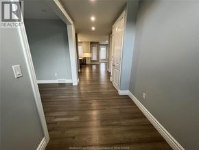 Belle River apartment for rent - A long hallway with wood floors and white walls.