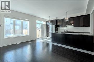 Ancaster townhouse for rent - A modern kitchen with black cabinets and a large island.