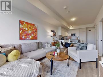 Oakville (Ro River Oaks) condo for rent - A living room with a grey couch, a yellow pillow, a coffee table and a painting on the wall.
