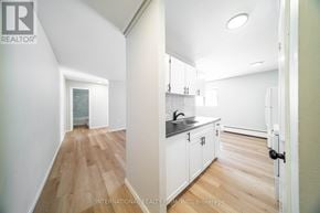 St. Thomas multi-family for rent - A white kitchen with a sink and cabinets.