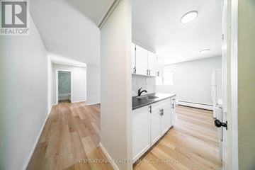 St. Thomas multi-family for rent - A white kitchen with a sink and cabinets.