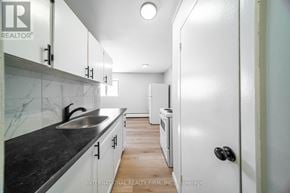St. Thomas multi-family for rent - A modern kitchen with white cabinets and a black countertop.