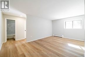 St. Thomas multi-family for rent - A room with wooden flooring and white walls.