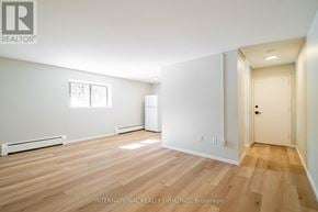 St. Thomas multi-family for rent - A room with wooden flooring and white walls.