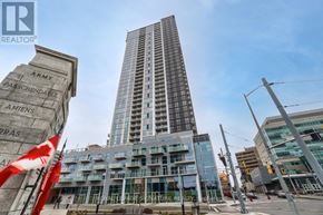 Kitchener condo for rent - A tall building with a sign that reads "ARMY" in front of it.