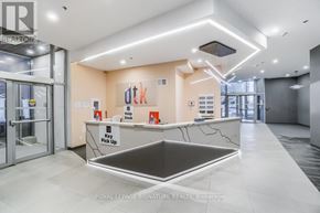 Kitchener condo for rent - A modern office lobby with a reception desk and a key pick up area.