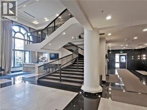 Hamilton condo for rent - A spacious interior of a building with a staircase and a reception area.
