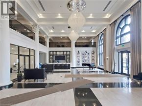 Hamilton condo for rent - A large, well-lit, and spacious living room with a piano and a chandelier.