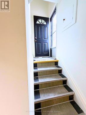 Toronto (Clanton Park) apartment for rent - A set of stairs leading to a dark blue door.