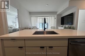 Innisfil condo for rent - A kitchen with a sink and a countertop.