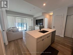Innisfil condo for rent - A kitchen with a white countertop and a sink is shown.
