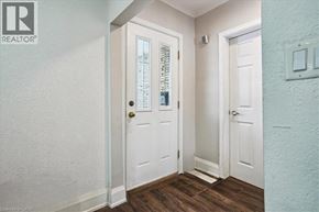 Stoney Creek apartment for rent - A white door with a glass window and a black handle.