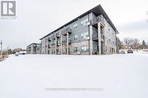 Bonnechere Valley apartment for rent - A large building with a balcony on the second floor.