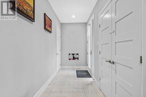 Ottawa apartment for rent - A hallway with white walls and a tiled floor.