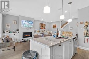 Ottawa apartment for rent - A well-lit, spacious kitchen and living room with a fireplace and a television.
