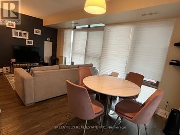 Toronto (Clanton Park) condo for rent - A living room with a white table and chairs.