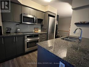 Toronto (Clanton Park) condo for rent - A kitchen with granite countertops and stainless steel appliances.