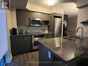 Toronto (Clanton Park) condo for rent - A kitchen with a granite countertop and stainless steel appliances.