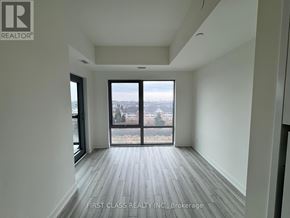 Clarington (Bowmanville) condo for rent - A room with a view of a cityscape through large windows.