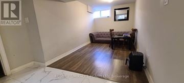Toronto (Woburn) apartment for rent - A living room with a grey couch and a small table.