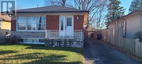 Toronto (Woburn) apartment for rent - A red brick house with a white door and windows.