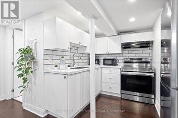 Aurora (Aurora Highlands) apartment for rent - A white kitchen with a plant on the left and a stove top oven on the right.