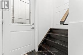 Aurora (Aurora Highlands) apartment for rent - A white door with a glass panel and a set of stairs leading up to it.