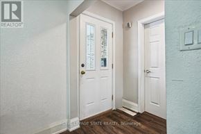 Hamilton (Stoney Creek) apartment for rent - A white door with a glass window and a black handle is in a room.