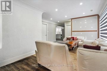 Hamilton (Stoney Creek) apartment for rent - A living room with a white sofa and a wooden coffee table.