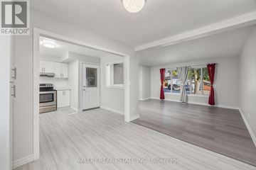 Cambridge apartment for rent - A spacious room with a kitchen area and a living room with a couch and a window.