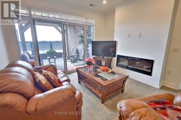 London North (North R) condo for rent - A living room with a brown leather couch and a wooden coffee table.