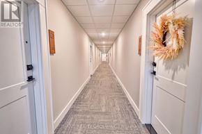 London North (North R) condo for rent - A hallway with a wreath on the wall and doors on both sides.