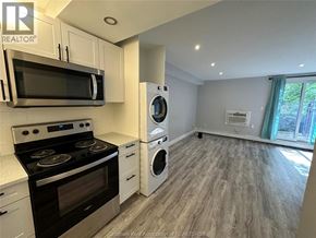 Chatham apartment for rent - A kitchen with a stove top oven, microwave, and dishwasher.